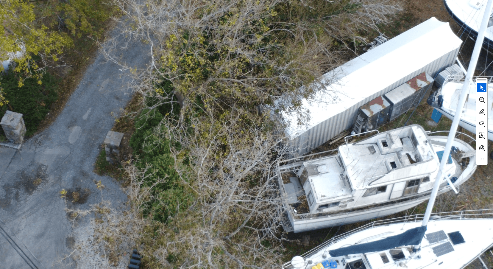 Unpermitted shipping container and abandoned vessel on neighboring property